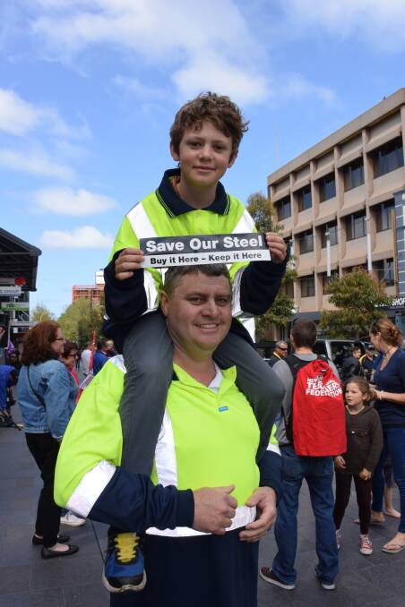  Jaryn O'Connor and his dad, Bluescope employee Simon O'Connor, don high-vis at Saturday's steel rally. Picture: Angela Thompson