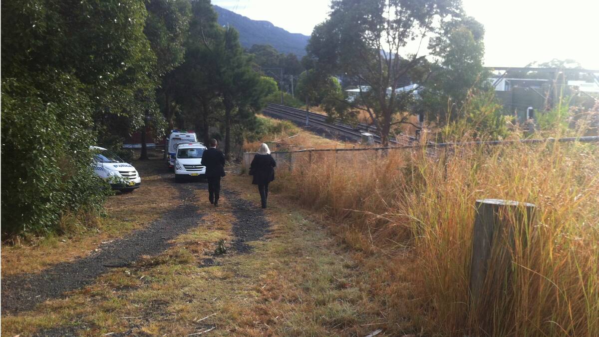 Detectives at the Bulli rail corridor Saturday morning where a man's body was discovered.