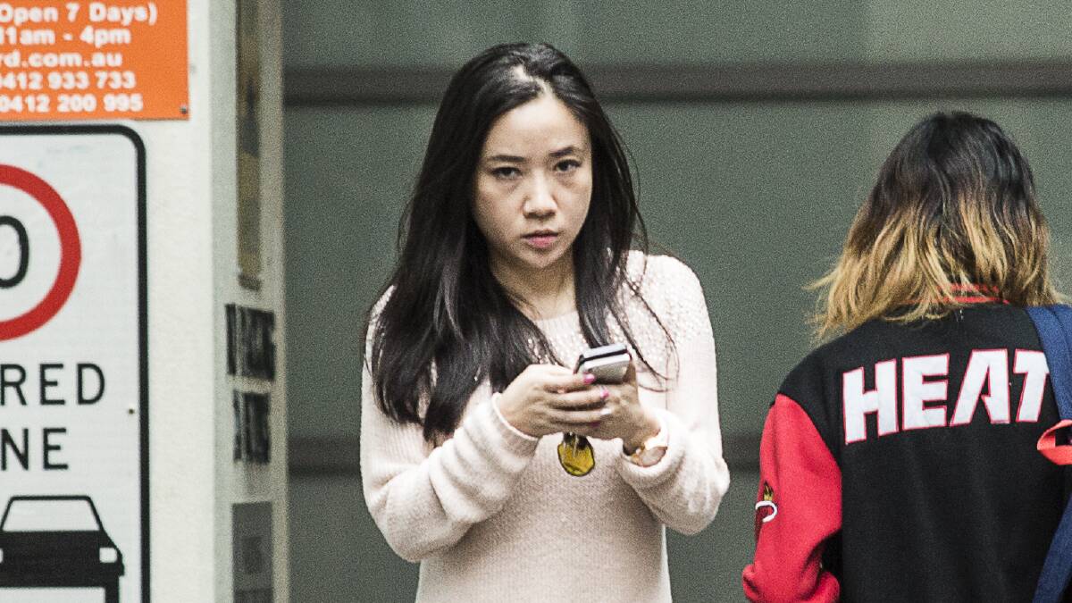 Yingying Dou leaves the Sydney premises where she works. Picture: DOMINIC LORRIMER