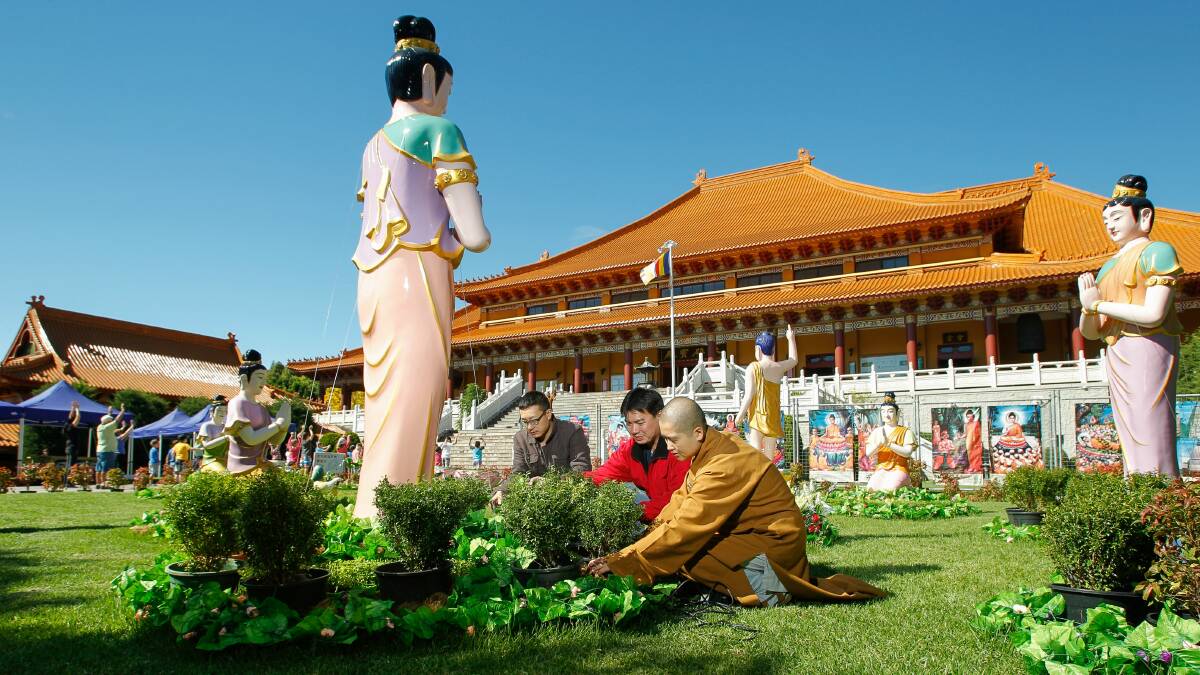 Venerable Zhi Li, Frank Hwang and Even Chen prepare the Lumbini Garden at Nan Tien Temple. Picture: CHRISTOPHER CHAN
