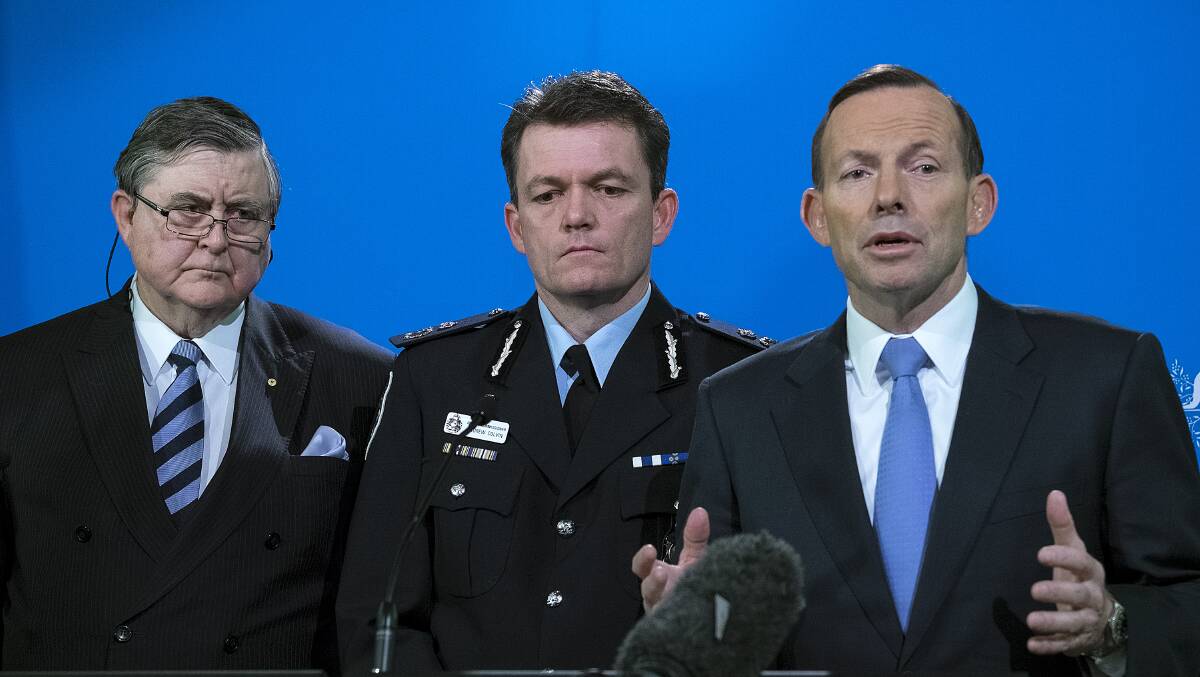 Prime Minister Tony Abbott on Friday, with ASIO Director General David Irvine and AFP Commissioner Andrew Colvin. Picture: LUIS ASCUI