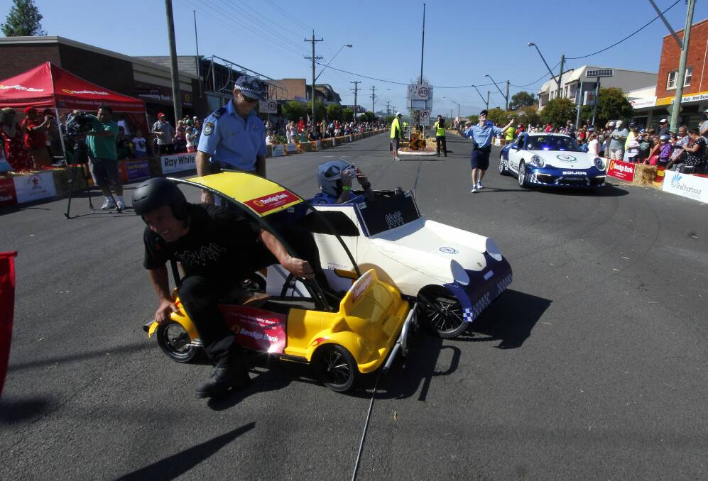 The Harbourside local area command’s push-powered Porsche 911 Carrera is no match for the Bendigo Bank buggy. Picture: ANDY ZAKELI