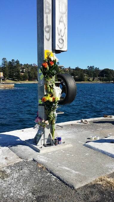 Flowers left at Kiama Harbour for Scott Carrigan.
