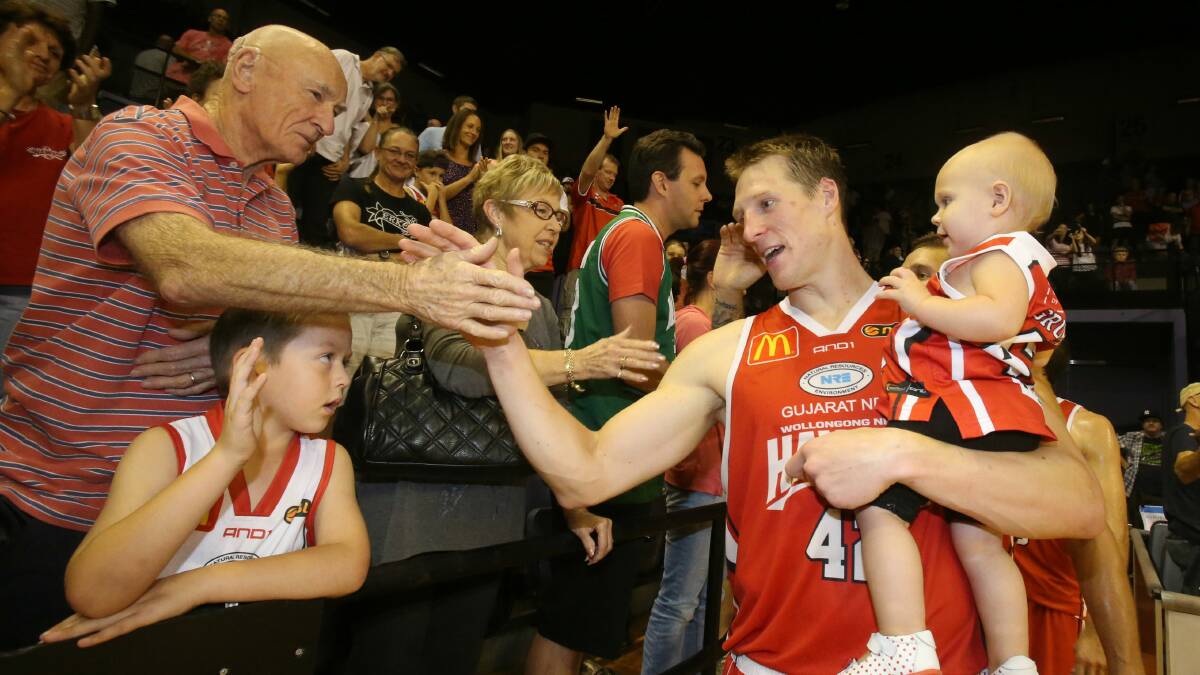 Hawks players get a high-five from fans after their NBL season comes to an end. Picture: ROBERT PEET