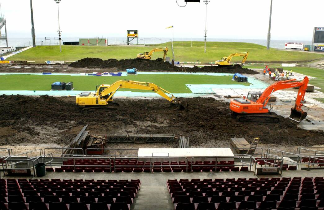 WIN Stadium is a hive of activity as the 4000 tonnes of dirt trucked in for the supercross event is removed from the field.