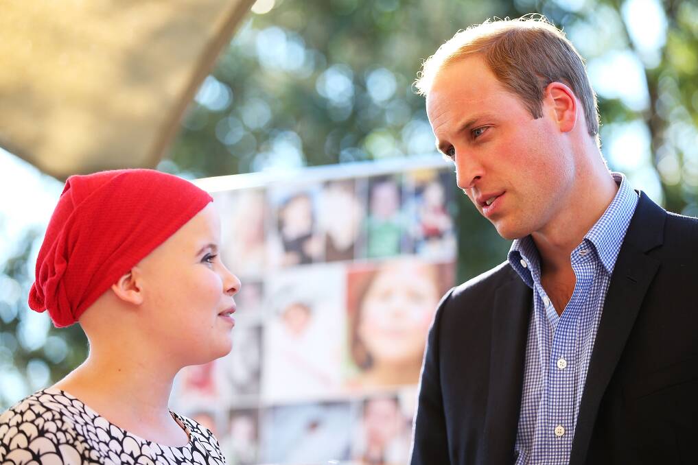 Prince William speaks with a girl in Bear Cottage, Sydney.  Picture: GETTY IMAGES