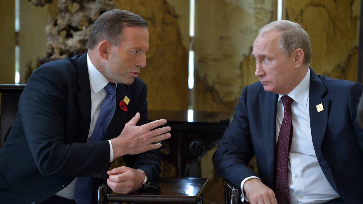 Australian Prime Minister Tony Abbott speaks with Russian President Vladimir Putin at the APEC leaders' summit in Beijing. Picture: AFP