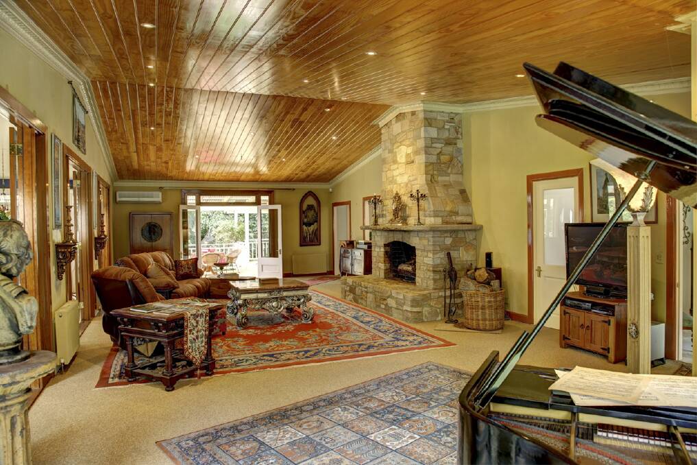 The formal sitting room features a tongue-in-groove timber ceiling and turn-of-the-century character.