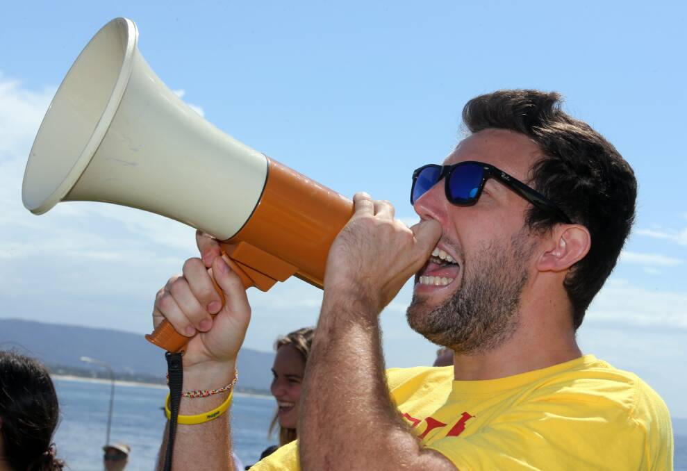 Organiser Nathaniel Harris leads a chant at the Wollongong lighthouse. Picture: ROBERT PEET