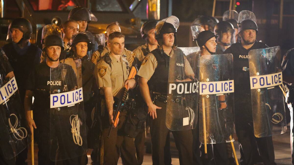Police watch as demonstrators protest at the killing of teenager Michael Brown. Picture: GETTY IMAGES