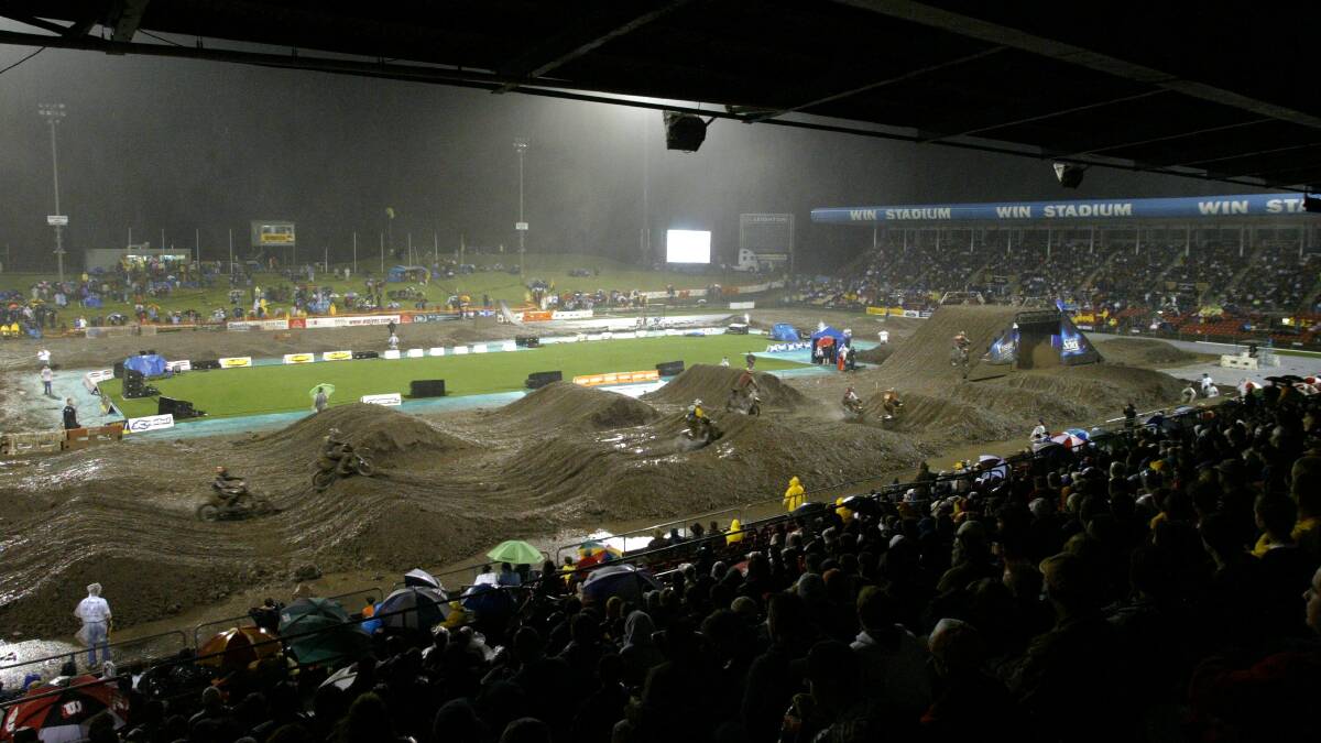 A muddy, soggy scene for Supercross spectators at WIN Stadium.