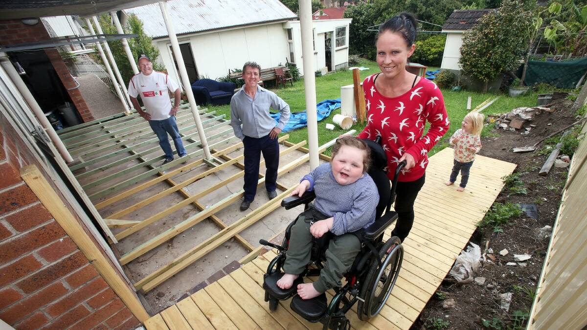 From left, Trevor De Costa and Steve Longden with Nicole Smith and her daughters Ila, 6, and Florence, 3. Big Hearts Illawarra is helping Ila's family build a sensory room. Picture: KIRK GILMOUR 