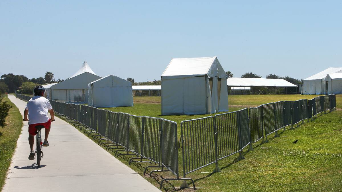 A cyclist makes his way past the tents that have been erected in Dalton Park for the finish of the annual Sydney to Gong race. Picture: KIRK GILMOUR