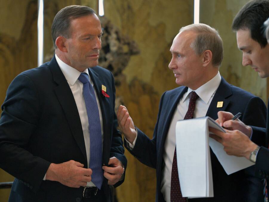 Tony Abbott speaks to Vladimir Putin in Beijing on Tuesday. Picture: ALEXEY DRUZHININ