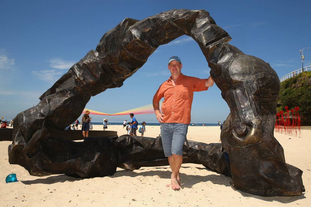 American artist Peter Lundberg poses with his sculpture ''Ring'' after winning Sculpture by the Sea 2014. Picture: GETTY IMAGES