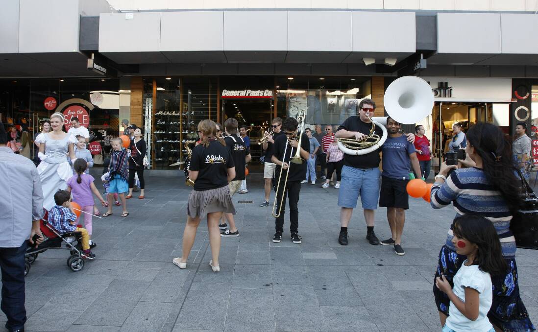 Hot Potato band members jam in Crown Street Mall. Picture: ANDY ZAKELI