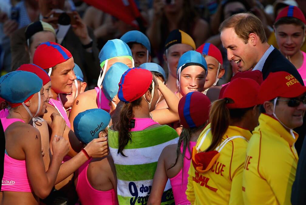 Prince William, Duke of Cambridge, speaks to children at Manly Beach. Picture: GETTY IMAGES