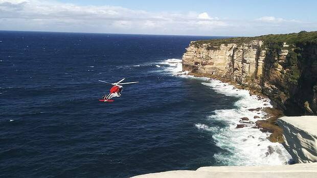 A rescue helicopter hovers off Little Marley Beach after a bushwalker fell to his death. Picture: JENNA MOLLROSS