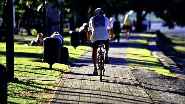 Different strokes: a cyclist in Cairns, where bicycles are allowed on the footpath. Picture: PHIL CARRICK