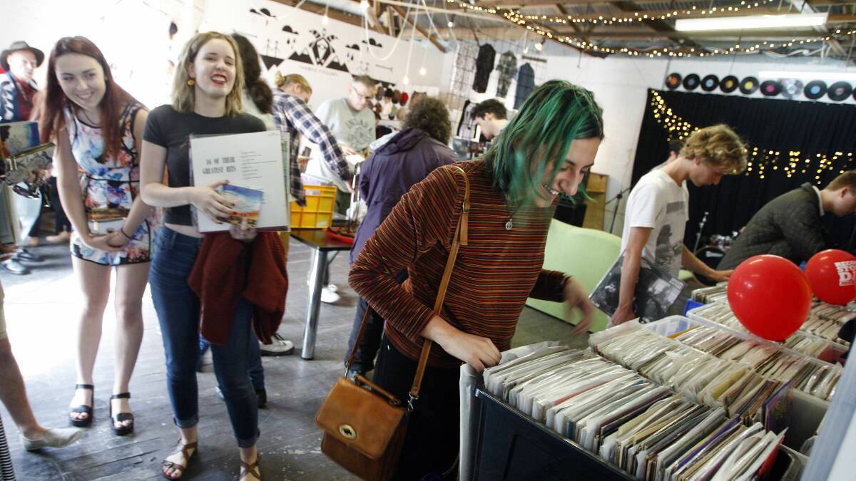 Krystal Zalloua of Albion Park checks out the collections for sale at Crown Lane record store Music Farmers. Picture: ANDY ZAKELI