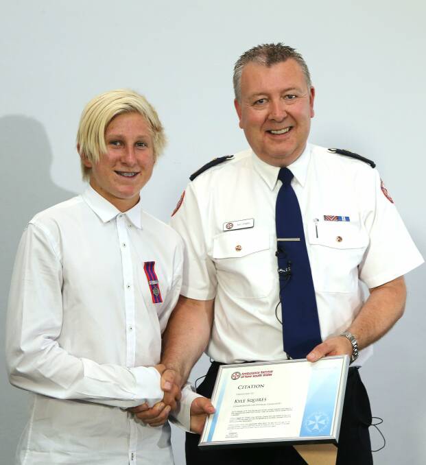 Ambulance chief executive Ray Creen gives the Commendation for Courage award to Kyle Squires. Picture: KIRK GILMOUR