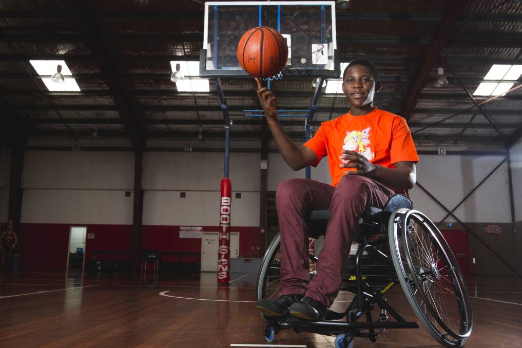 Frank Dushimirimana tries his new wheelchair, which will help as he strives to become a professional wheelchair basketball player. Picture: CHRISTOPHER CHAN