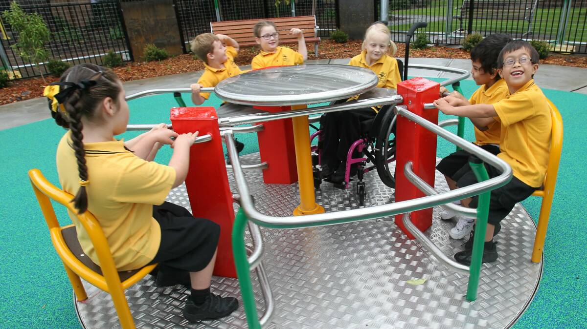 Children give Luke's Place in Corrimal a test run on Thursday. Picture: GREG TOTMAN