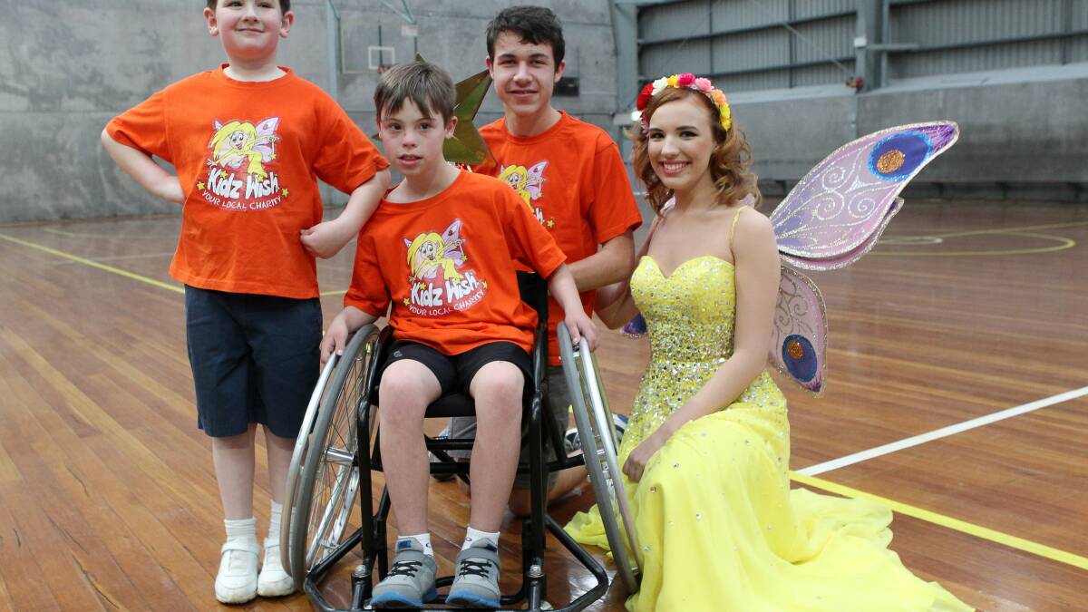 Happy days: Dylan McKay, left, Caleb Jordan in chair, Dylan Claydon and the Kidswish fairy. Caleb, 10, has Down syndrome and moderate hearing loss and has been attending KidzWish since infancy. Picture: GREG TOTMAN