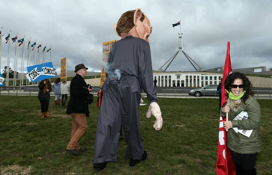 'Pants on fire': The Tony Abbott puppet during the Bust the Budget rally on the front lawn of Parliament House in Canberra on Sunday. Picture: ALEX ELLINGHAUSEN