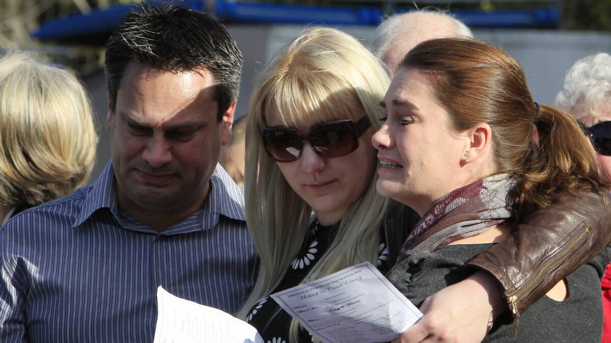 The son and daughter of Carol Clancy, Andrew Malcolm  (with wife Yuliya Tsekhanovich) and Jane Malcolm, right, at  the memorial service at Albion Park Public School on Friday. Picture: ANDY ZAKELI