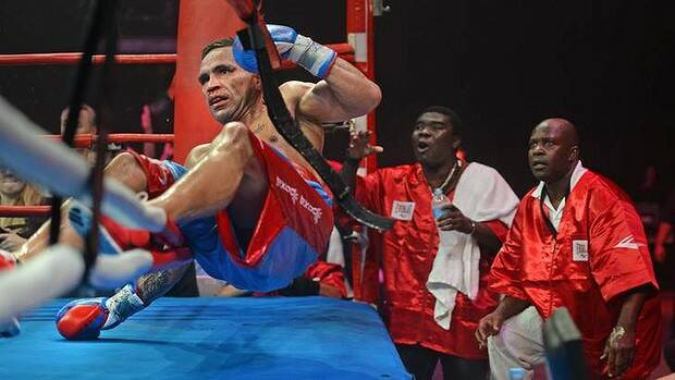 Anthony Mundine is knocked to the ground by Joshua Clottery. Picture: MARINA NEIL