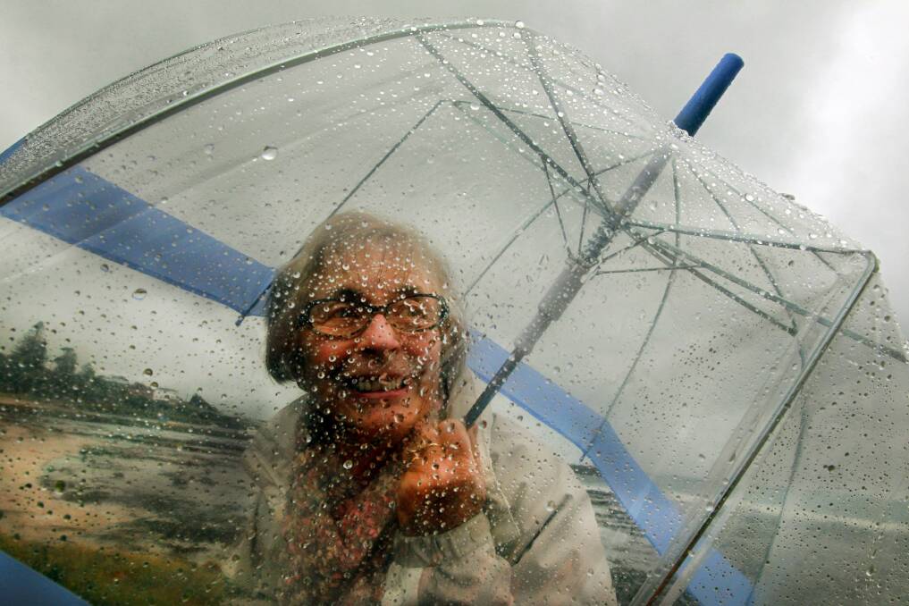 Mary Foy of Shell Cove takes shelter on Sunday. 