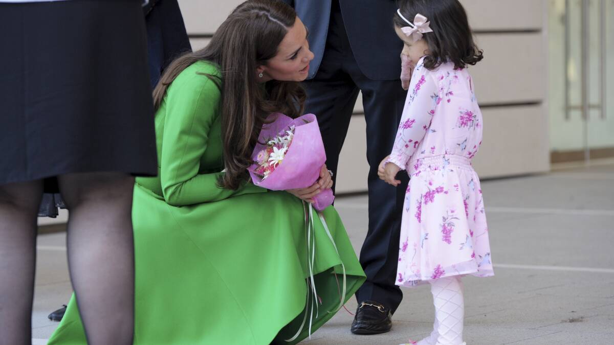 Catherine is greeted and presented with a bouquet of flowers by Wilhelmina, 3. Picture: GRAHAM TIDY