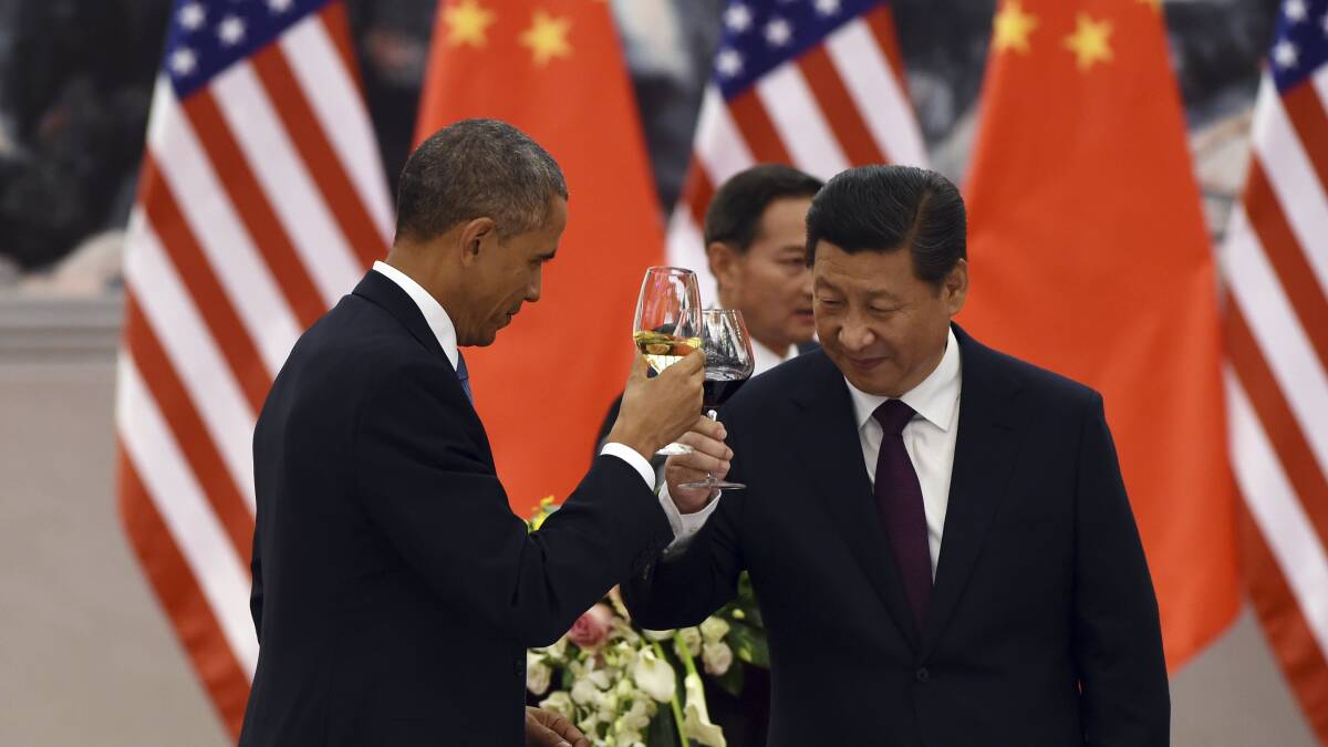 Historic deal: Barack Obama and Xi Jinping toast at an APEC lunch. Picture: AP