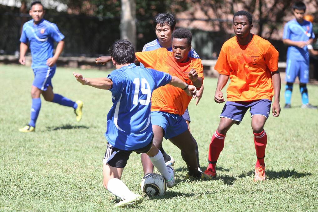 A game of football at the Illawarra Multicultural Services’ Harmony Day celebrations on Saturday. Picture: SYLVIA LIBER