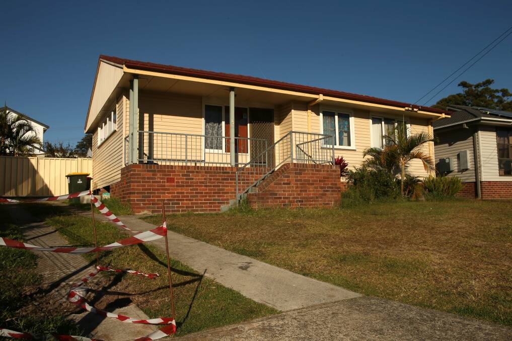 The home in Echuca Crescent, Koonawarra, where shots were fired last night. The boarded-up window near the door can be seen. Picture: KIRK GILMOUR