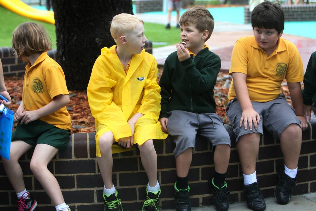 School children take a breather from having fun at the new Luke's Place playground. Picture: GREG TOTMAN