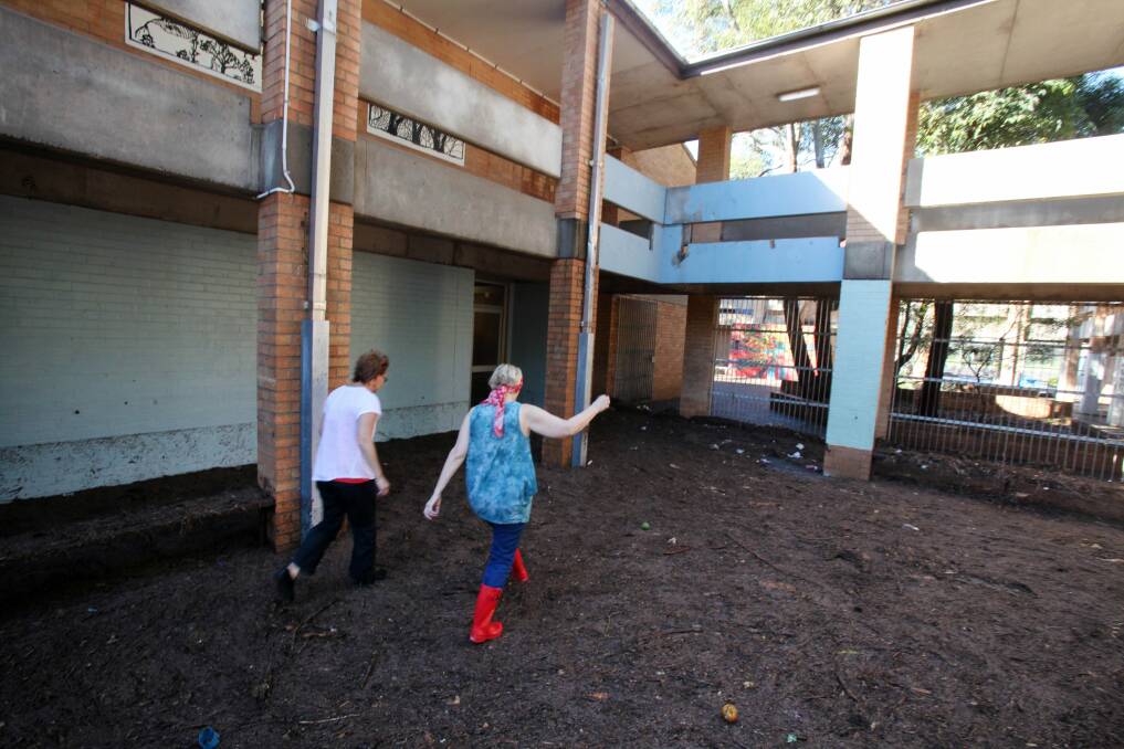 Bulli High staff inspect some of the damage done to the school by Monday night's storms and floods. Picture: KIRK GILMOUR