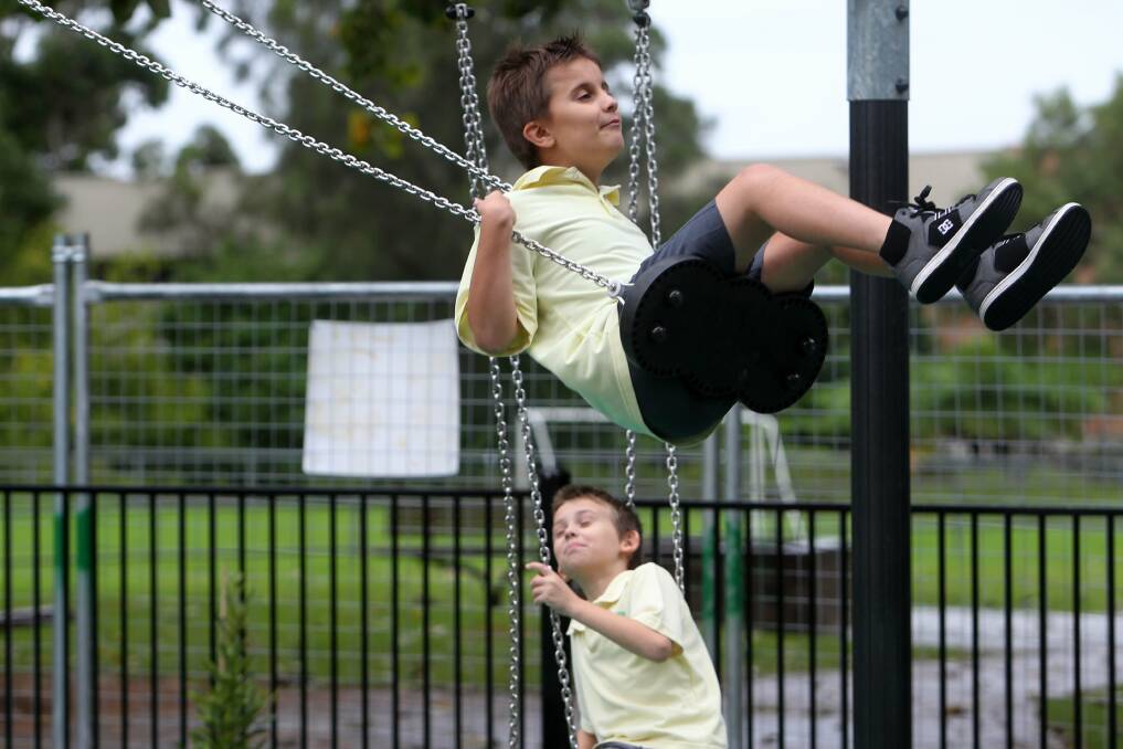 Parameadows children Adrian (on swing) and and Luke test out Luke's Park ahead of its official opening on Friday. Picture: GREG TOTMAN