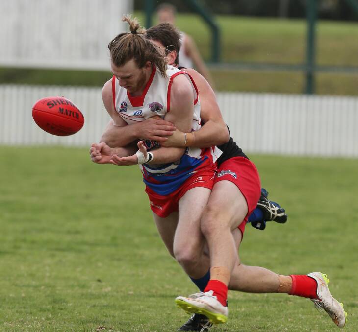 Wrapped up: Wollongong Bulldogs’ Keegan Litchfield is tackled strongly during Wollongong Lions’ 30 point win at North Dalton Park. The Lions are into the grand final, while the Bulldogs face Northern Districts. Picture: ROBERT PEET
