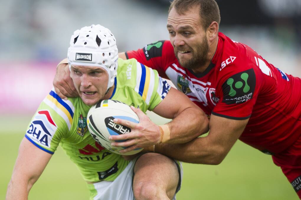 Inspired: Dragons winger Jason Nightingale tackles Raiders centre Jarrod Croker in their NRL clash in Canberra. The Dragons trailed 18-0 but in an inspired second half fightback won 22-20. Picture: JAY CRONAN
