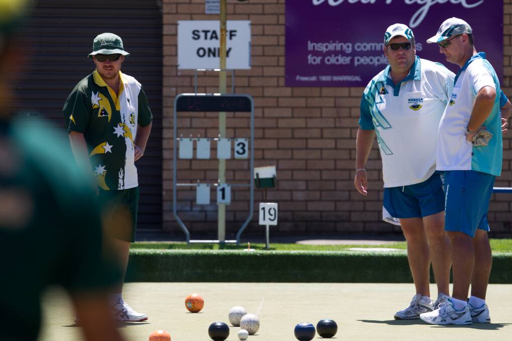 Discussion: Dapto Citizens' Ben Ford with (right) Warilla's Jeremy Henry and (far right) Jamie Mitchell look over an end during Warilla's 24-6 victory in the Illawarra Triples final at Warilla Bowling Club. Picture: CHRISTOPHER CHAN