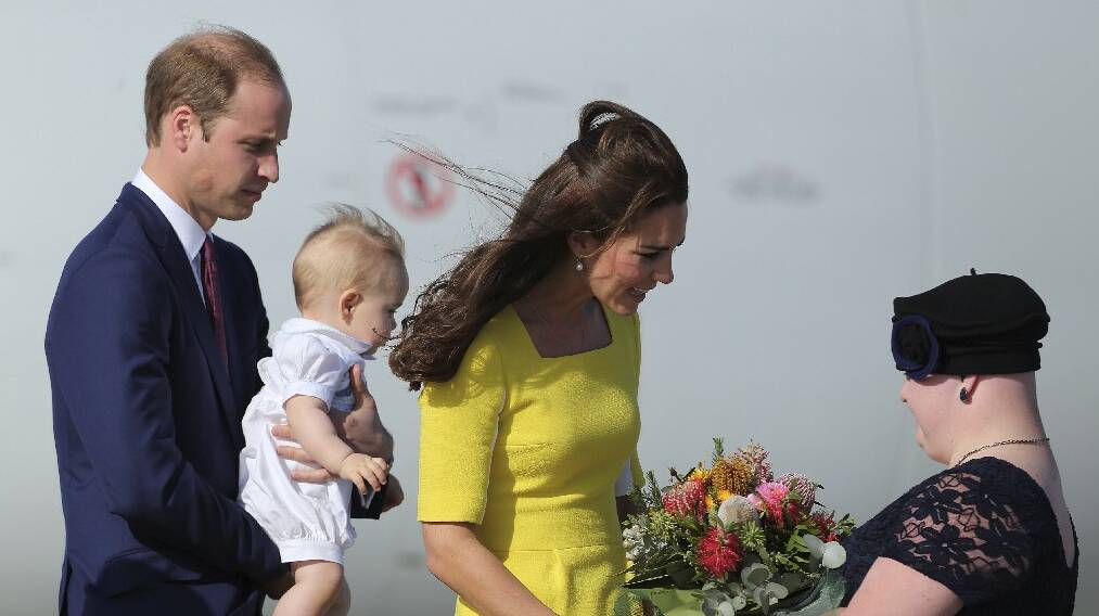 Her Royal Highness, Catherine Duchess of Cambridge receives flowers from Joscelyn Sweeney, with His Royal Highness Prince William, Duke of Cambridge holding Prince George on arriving at Sydney Airport. Picture: KATE GERAGHTY