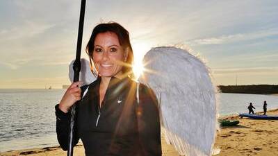 Melinda Holman, of Pokolbin, is coming to Wollongong and Shellharbour this year after paddling like an golden angel at dawn at Horseshoe Beach in Newcastle for Angels at Work in 2014. Picture by Greg Ellis.

