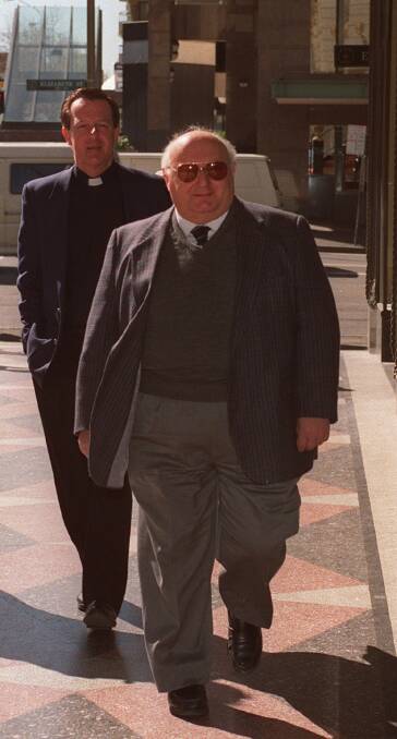 Former parish priest of Edmund Rice, Father Peter Comensoli (front), served 18 months' jail for sex abuse offences. 
