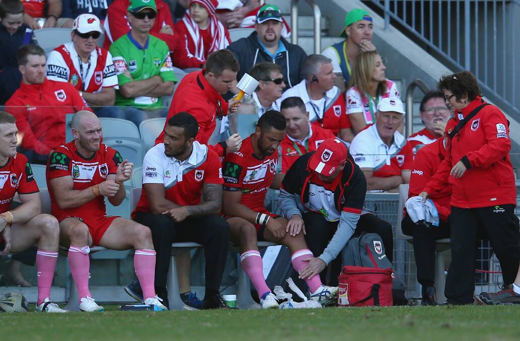 Dragons halfback Benji Marshall receives attention to his injured knee at WIN Stadium on Sunday. Picture: GETTY IMAGES
