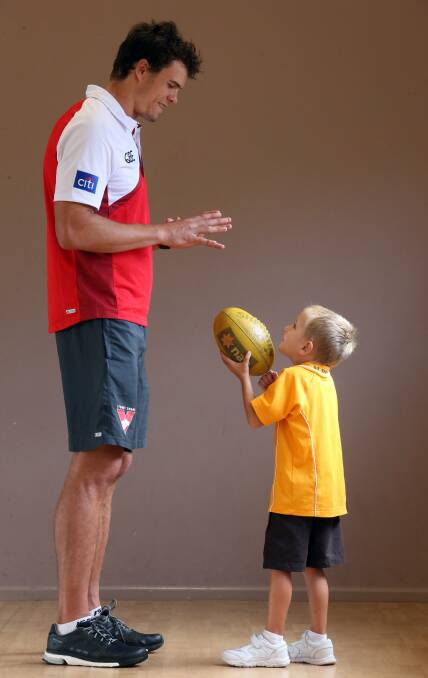 Sydney Swans player Mike Pyke with St Therese Primary School student Pacey Moylan on Tuesday. Picture: ROBERT PEET