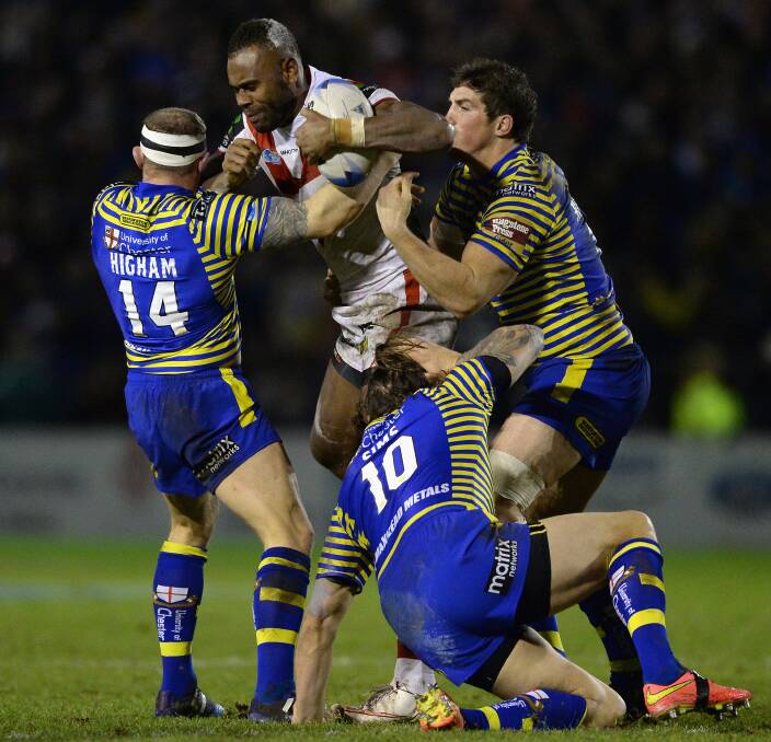Eto Nabuli of the Dragons is tackled by Micky Higham and Ashton Sims of Warrington Wolves during the World Club Series match at Halliwell Jones Stadium. Picture: GETTY IMAGES