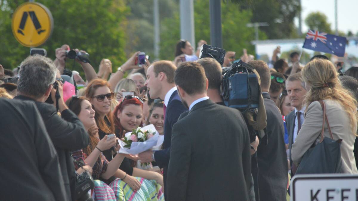 Surrounded by security and the British press, William makes the day for some of those waiting for a glimpse of Royalty at Elizabeth, South Australia. Picture: Joanne Fosdike