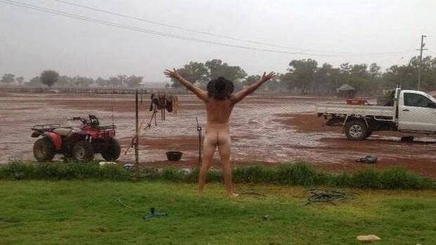 Cobar farmer James Rogers celebrating the arrival of rain. Photo: Jody Fraser
